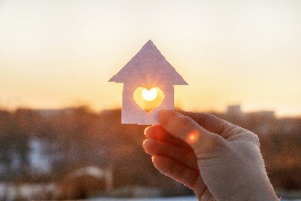 House of paper with a heart against sunlight